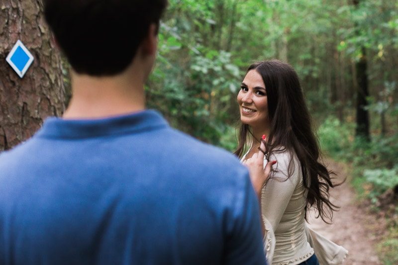 Shelby twirling her hair while looking back at Brandon and flirting with him. Brandon and Shelby linger over each other for a kiss. Photo by Arkansas Wedding Collection.