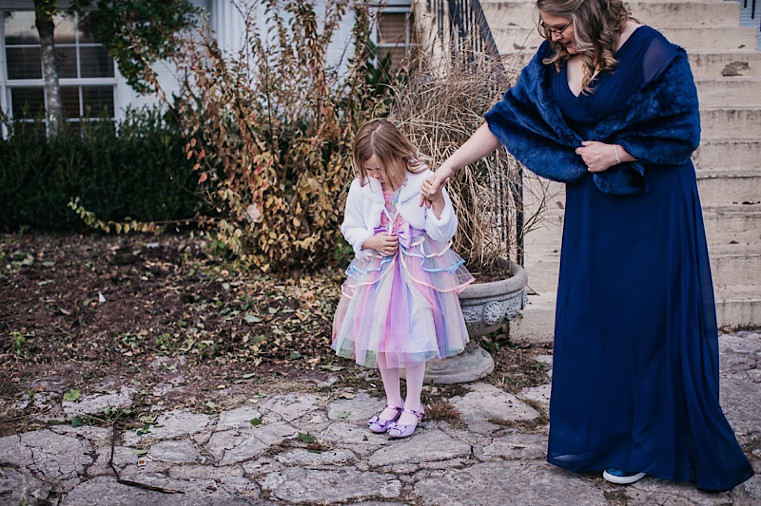 Bride’s daughter showing her dress to groom