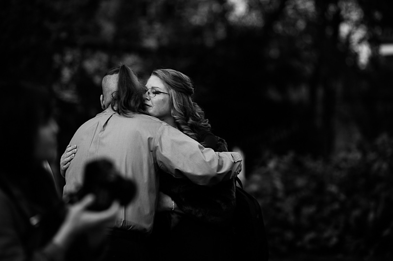 Bride hugging groom’s son before wedding