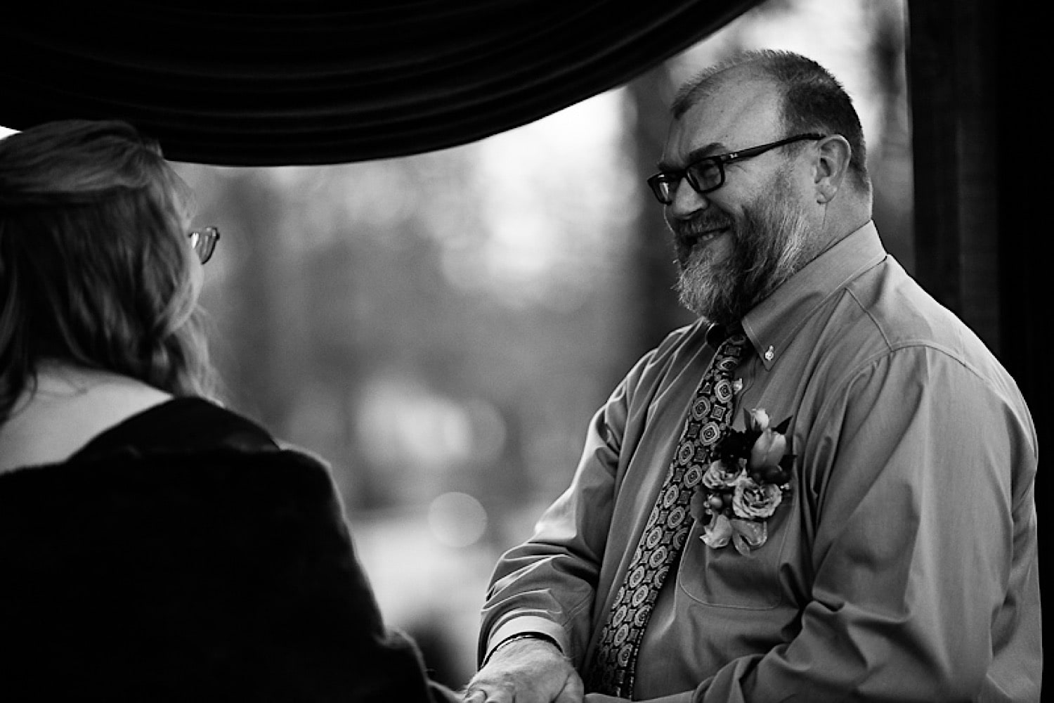 Groom smiling at bride