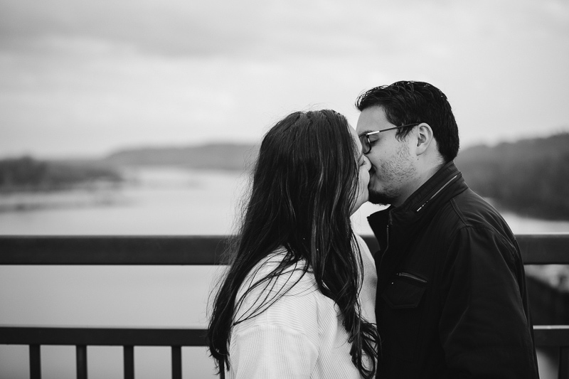 couple kissing on bridge