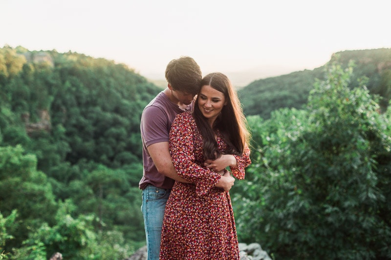 Engaged couple standing on the overlook at Petit Jean State Park. Photo by Arkansas Wedding Collection.