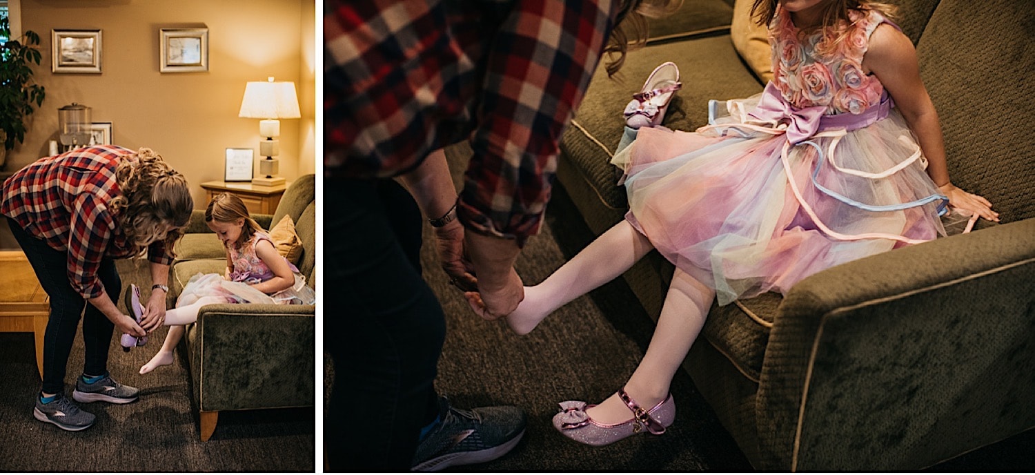 Bride putting shoes on daughter