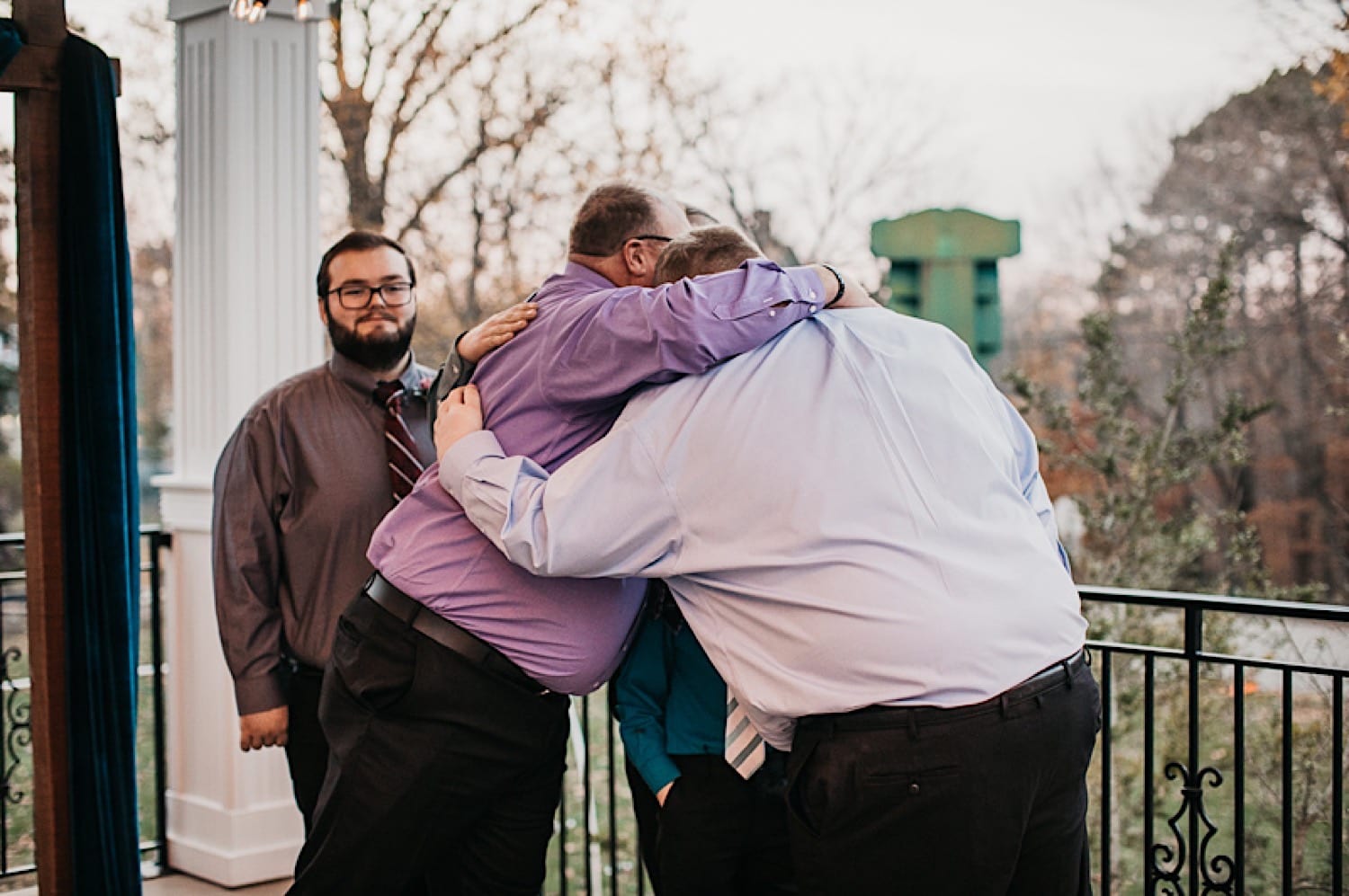 Groom hugging groomsmen