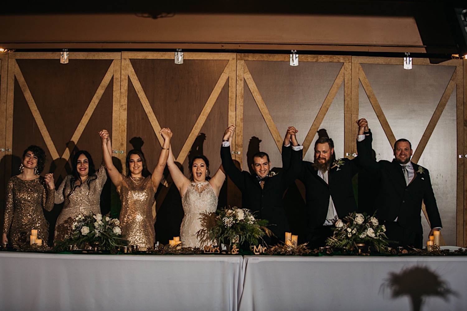 bridal-party-holding-hands-and-bowing