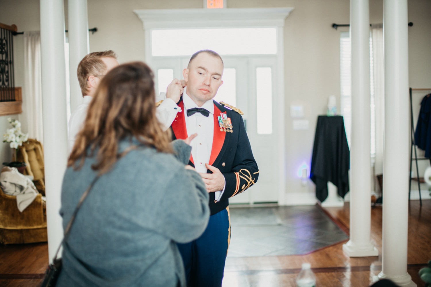 groom-grabbing-offier-blue-mess-jacket