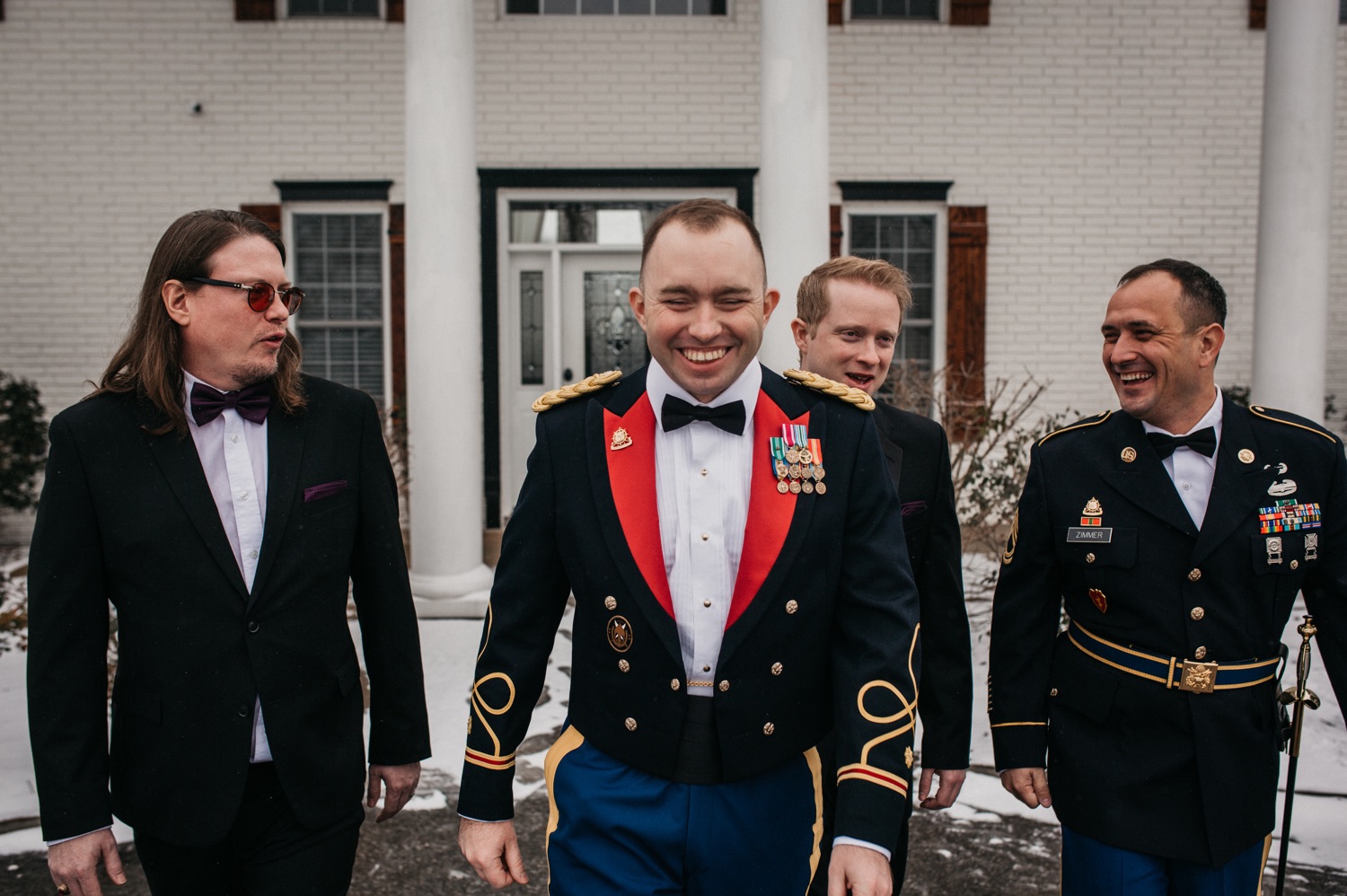 groom-and-groomsmen-outside-mansion-at-the-orchard
