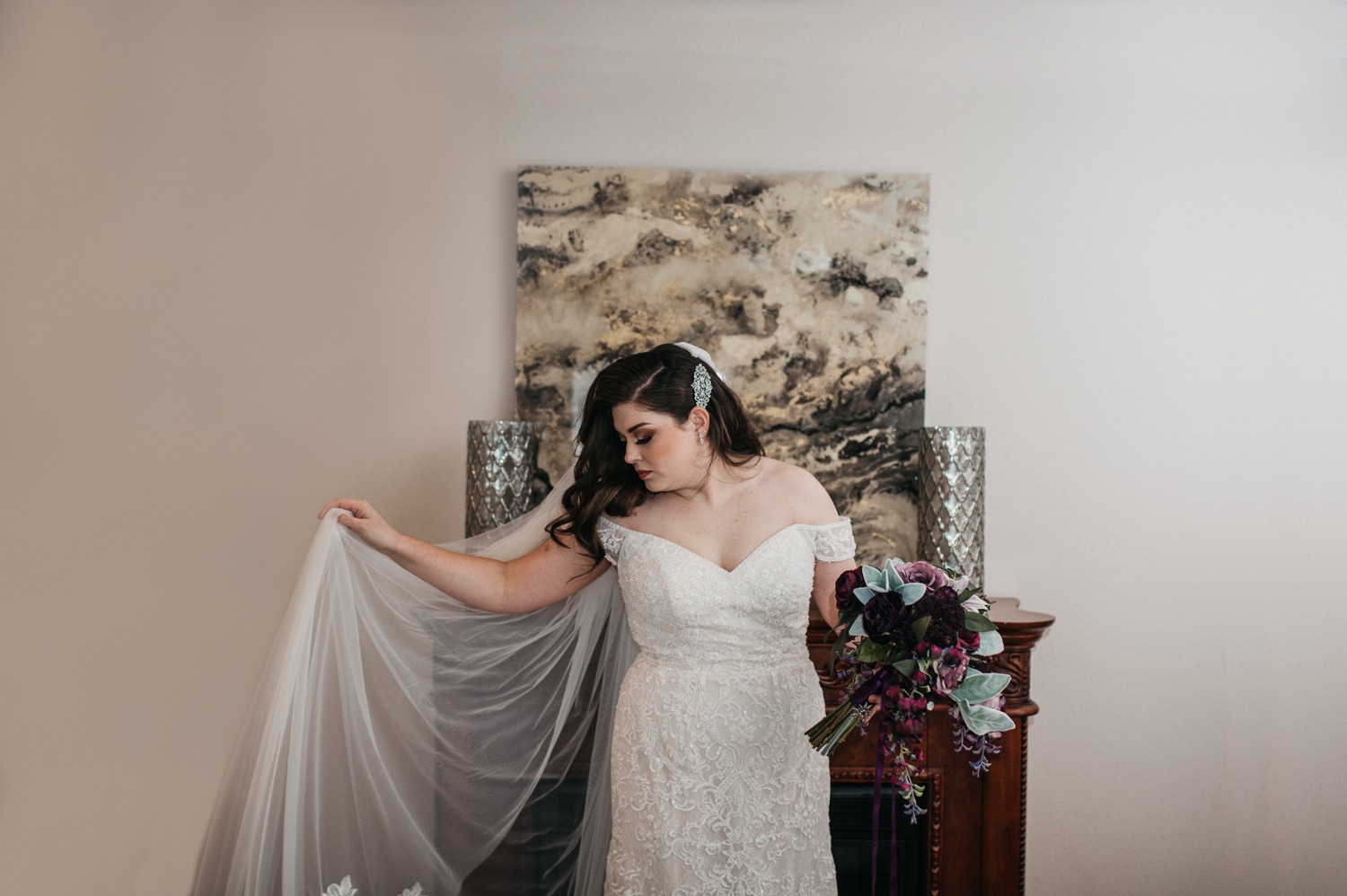 bride-standing-in-front-of-white-wall