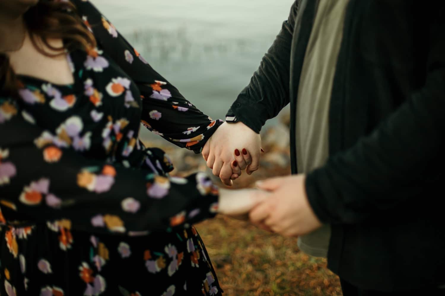 couple-holding-hands-by-the-arkansas-river